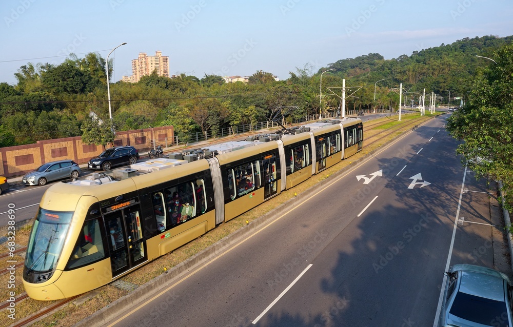 View of a modern tram of Ankeng Light Rail Transit passing through a curve on the green grassy lawn between traffic lanes in Xindian District, New Taipei City, Taiwan
Modern  efficient transportation