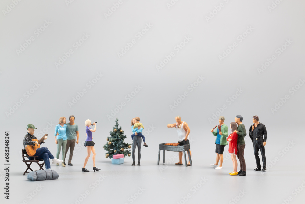 Miniature Families are joyfully celebrating and dining together. Concept of a Merry Christmas Miniature Families are joyfully celebrating and dining together. Concept of a Merry Christmas