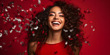 Beautiful happy Afroamerican woman on red background with confetti in the air