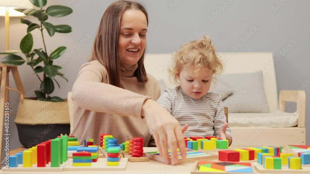 Child imagination. Creative play. Educational toys. Preschool learning. Early childhood. Young mother playing with her toddler baby daughter in home interior. Child imagination. Creative play. Educational toys. Preschool learning. Early childhood. Young mother playing with her toddler baby daughter in home interior.