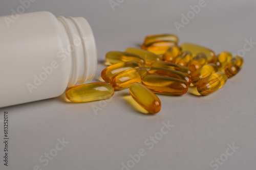 Omega-3 capsules lie in white bottle. Fish oil tablets. omega 6, 9, top view with copy space.