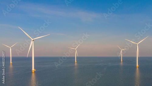 Windmill farm in the ocean Westermeerwind park, windmills isolated at sea on a beautiful bright day in Netherlands Flevoland Noordoostpolder photo