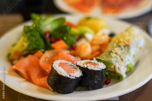 Japanese cuisine. Sushi, rolls and fresh red fish on the plate