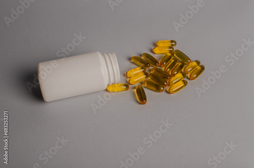 Omega-3 capsules lie in white bottle. Fish oil tablets. omega 6, 9, top view with copy space.