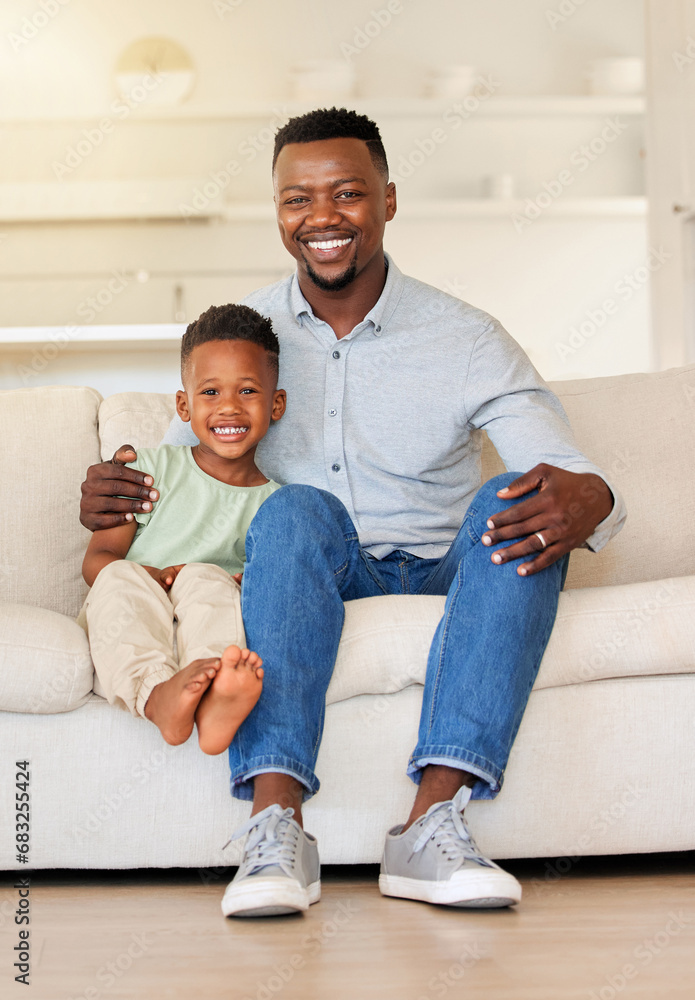 Happy, smile and portrait of child with father on sofa in the living room of modern house for bonding. Care, love and young African boy kid sitting with his dad on couch of lounge at home together.