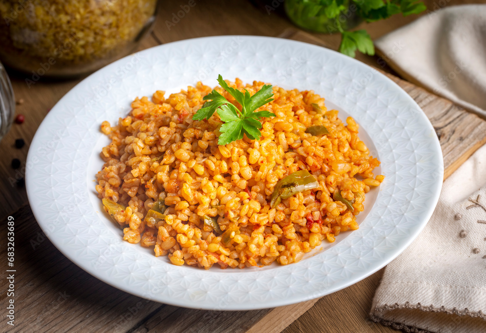 Traditional turkish bulgur pilaf with tomato sause in plate (Turkish name; meyhane pilavi) Traditional turkish bulgur pilaf with tomato sause in plate (Turkish name; meyhane pilavi)