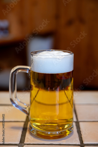 Freshly brewed German beer in craft brewery served in beer glass poured from keg