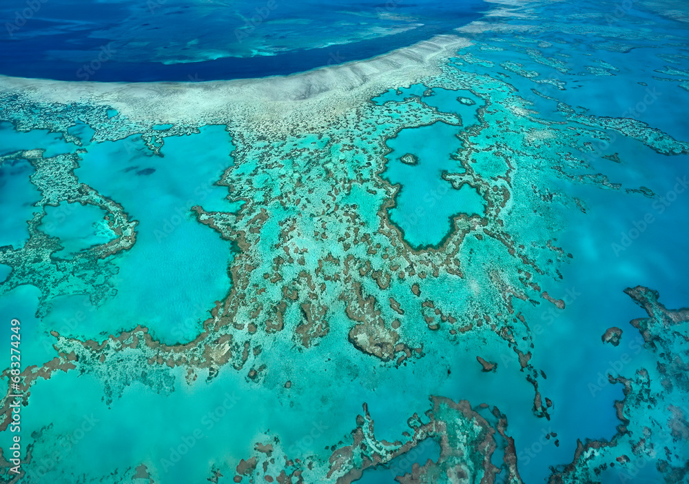 Aerial view of the coral reefs of the Whitsunday Islands off the coast of Queensland, Australia. - obrazy, fototapety, plakaty 