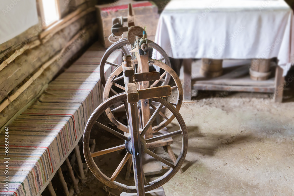 Old rustic wooden spinning wheels with foot drive