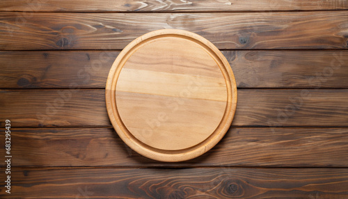 Wooden round empty board for pizza on wood table background, top view. Mockup for menu, recipe or any dish. Vertical image