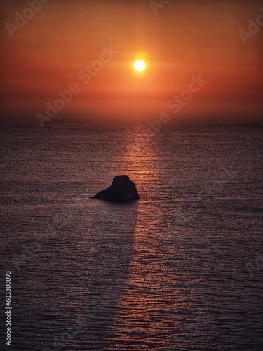 the lonly rock in the sea by the sunset