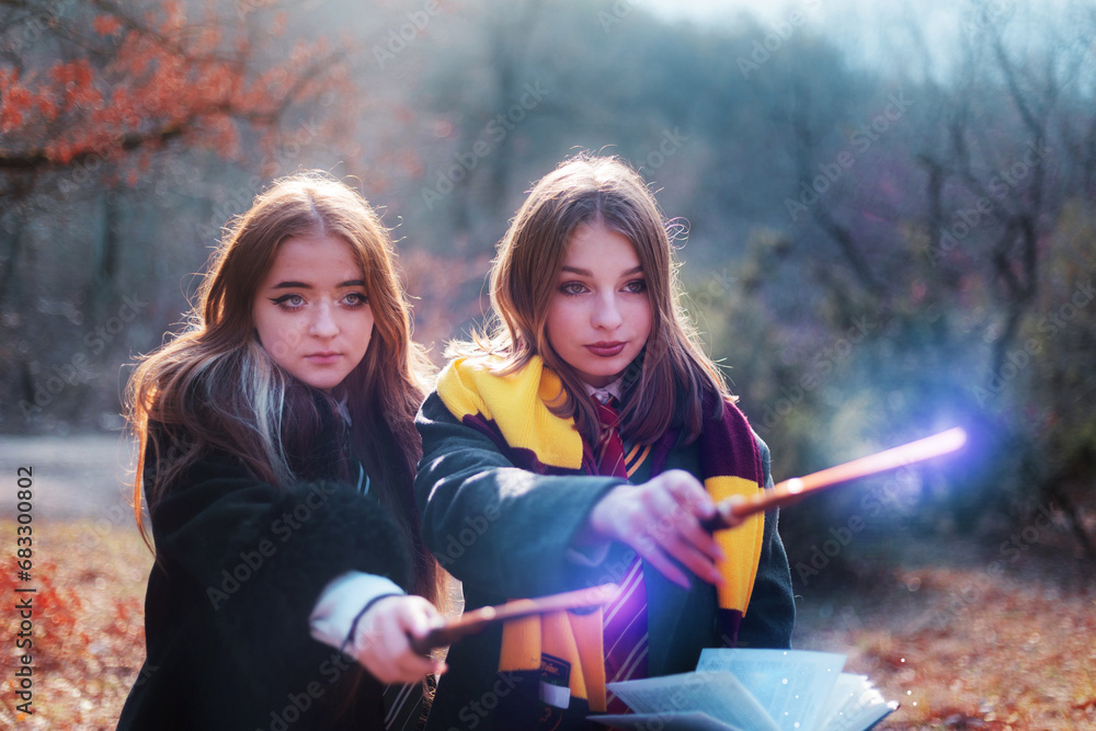 Naklejka premium two sorceresses in the forest casting a spell in the enchanted forest of Hogwarts