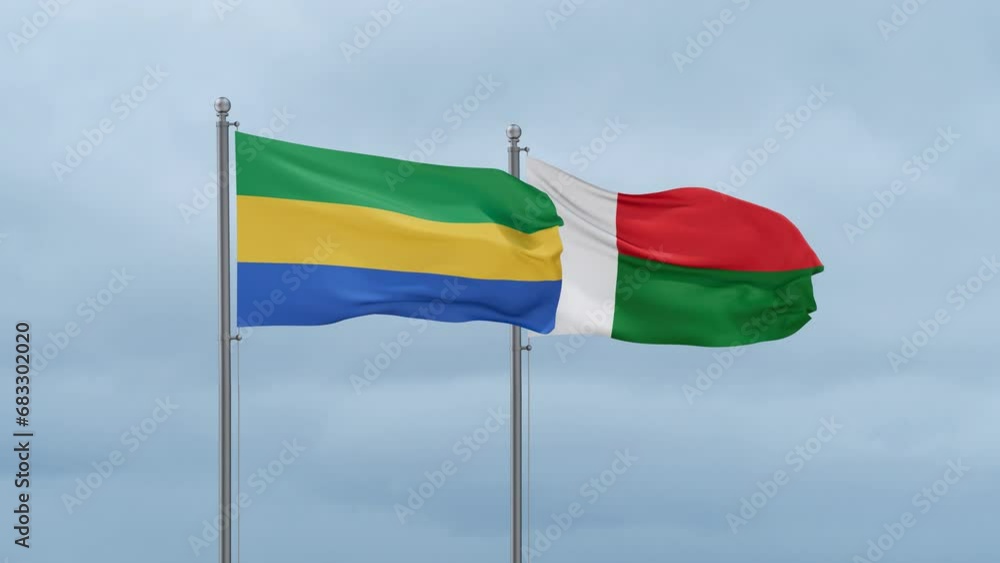 Madagascar flag and Gabon flag waving together on cloudy sky, endless seamless loop, two country relations concept Madagascar flag and Gabon flag waving together on cloudy sky, endless seamless loop, two country relations concept