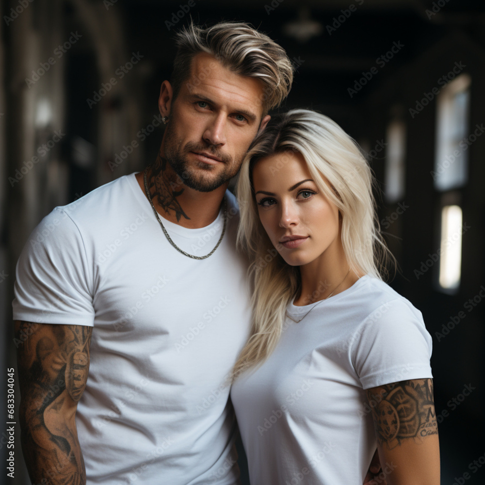 male and female models in cotton white t-shirts, couple posing, blonde man with tattoos on his arms, brunette girl, white cotton t-shirt, gray wall in the background male and female models in cotton white t-shirts, couple posing, blonde man with tattoos on his arms, brunette girl, white cotton t-shirt, gray wall in the background