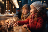 Children looking at sweets at the Christmas market.