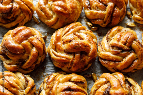 Traditional Swedish cardamom swirl buns - kardemummabullar, focus on the bun inside. Homemade sweet pastries.