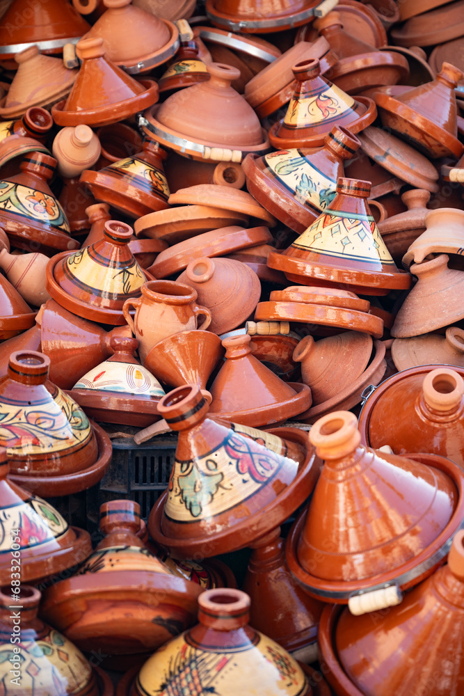 Stunning View of some handmade tajine in Marrakesh's souk Market, Morocco. A tajine is a heavy ceramic plate covered with a conical lid of the same material.