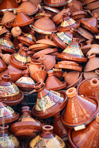 Stunning View of some handmade tajine in Marrakesh's souk Market, Morocco. A tajine is a heavy ceramic plate covered with a conical lid of the same material.