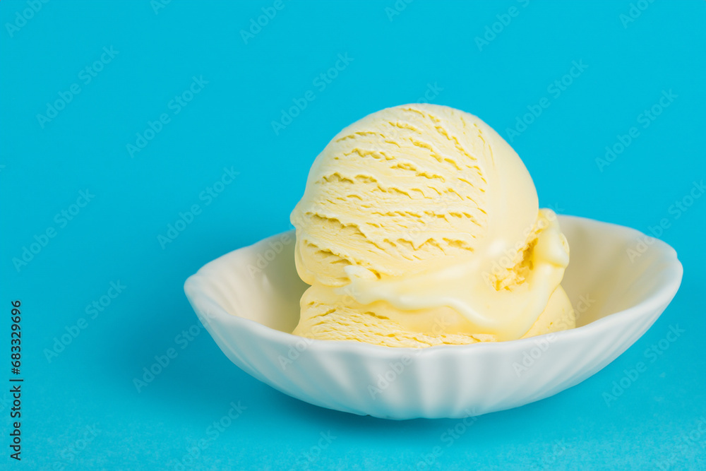 Scoop of vanilla ice cream in white bowl on blue background Scoop of vanilla ice cream in white bowl on blue background