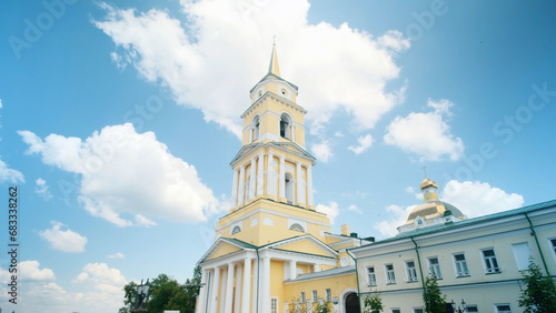 Low angle view of yellow Cathedral building on a blue cloudy summer sky background. Clip. Orthodox architecture theme. #683338262