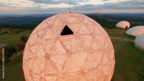 FPV, Abandoned radar station Pamir in Carpathian mountains, research station on top of the mountain in the Carpathians in Ukraine. large white balloons designs in the mountains among the fir trees photo