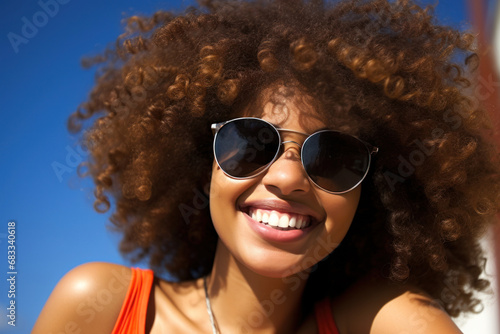 happy african american woman wearing sunglasses