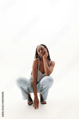 Beautiful young African American woman posing over white background. Vertical.