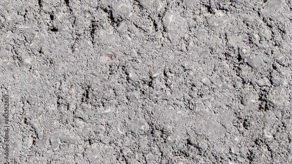 Asphalt rough gray surface, uniform texture background, rotating, turning, close-up macro, top view Asphalt rough gray surface, uniform texture background, rotating, turning, close-up macro, top view