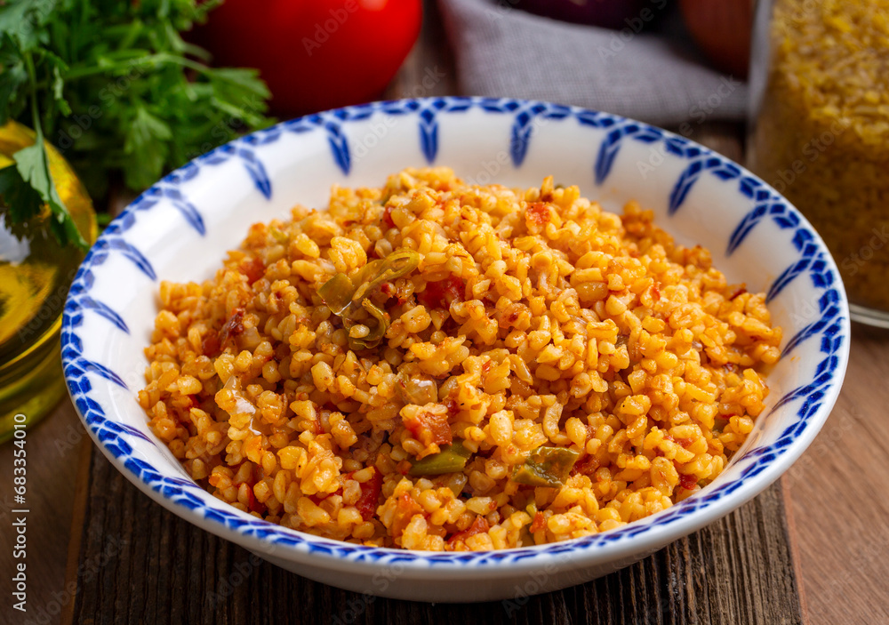 Traditional turkish bulgur pilaf with tomato sause in plate (Turkish name; meyhane pilavi) Traditional turkish bulgur pilaf with tomato sause in plate (Turkish name; meyhane pilavi)