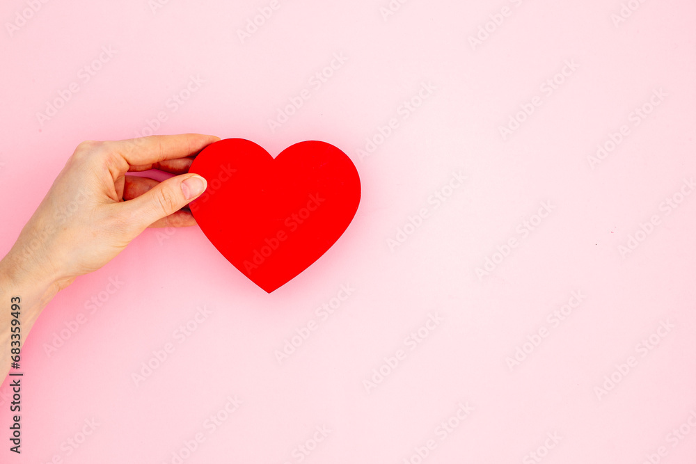 Medical insurance concept with red heart in female hands, top view Medical insurance concept with red heart in female hands, top view