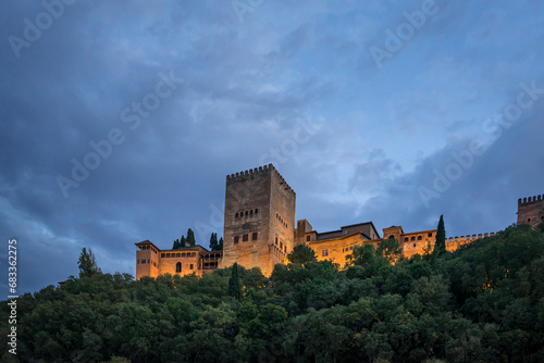 The Alhambra palace and fortress complex located in Granada, Andalusia, Spain. Foreground, the Comares Tower, part of the Nasrid Palaces. Night view