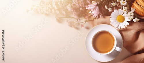 Breakfast themed card mockup with coffee croissant flowers and copy space on a sunlit desk