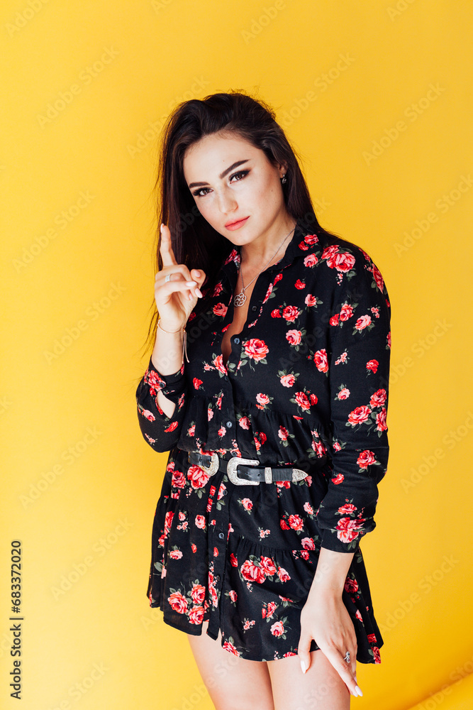 Beautiful brunette woman posing on yellow background Beautiful brunette woman posing on yellow background