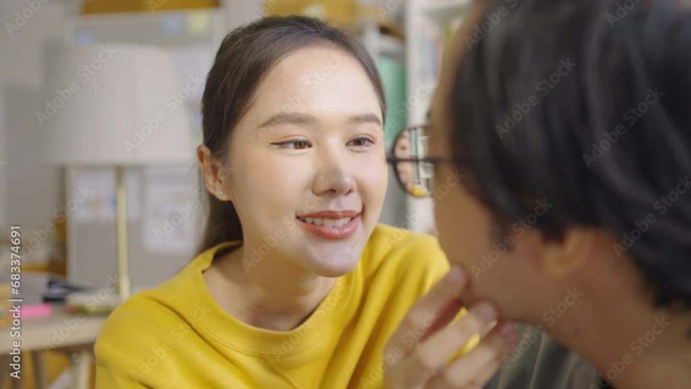 Asian Sensual loving teasing couple looking at each other while sitting in sofa living room Asian Sensual loving teasing couple looking at each other while sitting in sofa living room