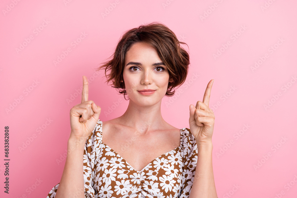 Photo of cute satisfied lady indicate fingers up above empty space ad blank isolated on pink color background Photo of cute satisfied lady indicate fingers up above empty space ad blank isolated on pink color background