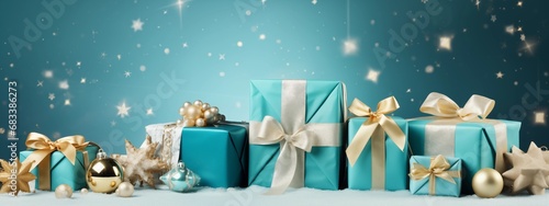 Christmas or birthday monotone background with  turquoise presents and gold ribbon on turquoise background with stars. Advertising banner with space for text, copy space photo