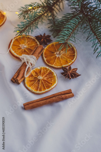 Dried orange slices with cinnamon sticks and star anise on a white background