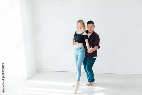 Couple dancers man and woman dancing in studio workout