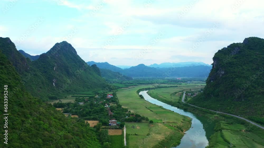 Village, drone and mountains with lake, boats and countryside for traveling, greenery and eco friendly. Neighbourhood, outdoor and houses in nature, peaceful and property in vietnam, rural and homes Village, drone and mountains with lake, boats and countryside for traveling, greenery and eco friendly. Neighbourhood, outdoor and houses in nature, peaceful and property in vietnam, rural and homes