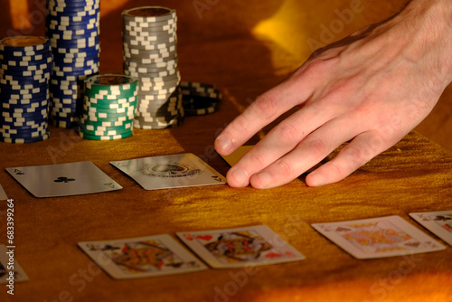 Playing Poker. Cards, chips in the sunny sunset light. Concept of sports board card games.