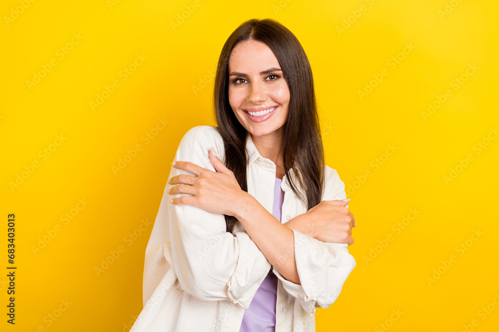 Photo of good mood satisfied woman with straight hairdo dressed stylish white jacket cuddle herself isolated on yellow color background Photo of good mood satisfied woman with straight hairdo dressed stylish white jacket cuddle herself isolated on yellow color background