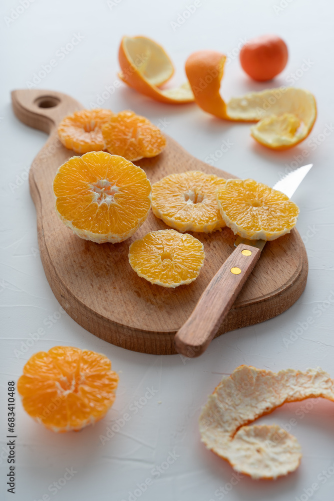 The process of making citrus jam. Orange and tangerine jam. Sliced fruits on a white background. The process of making citrus jam. Orange and tangerine jam. Sliced fruits on a white background.