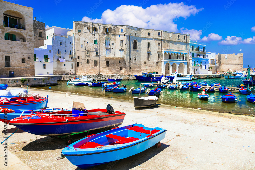 Traditional Italy - white town Monopoli with colorful fishinng boats in Puglia