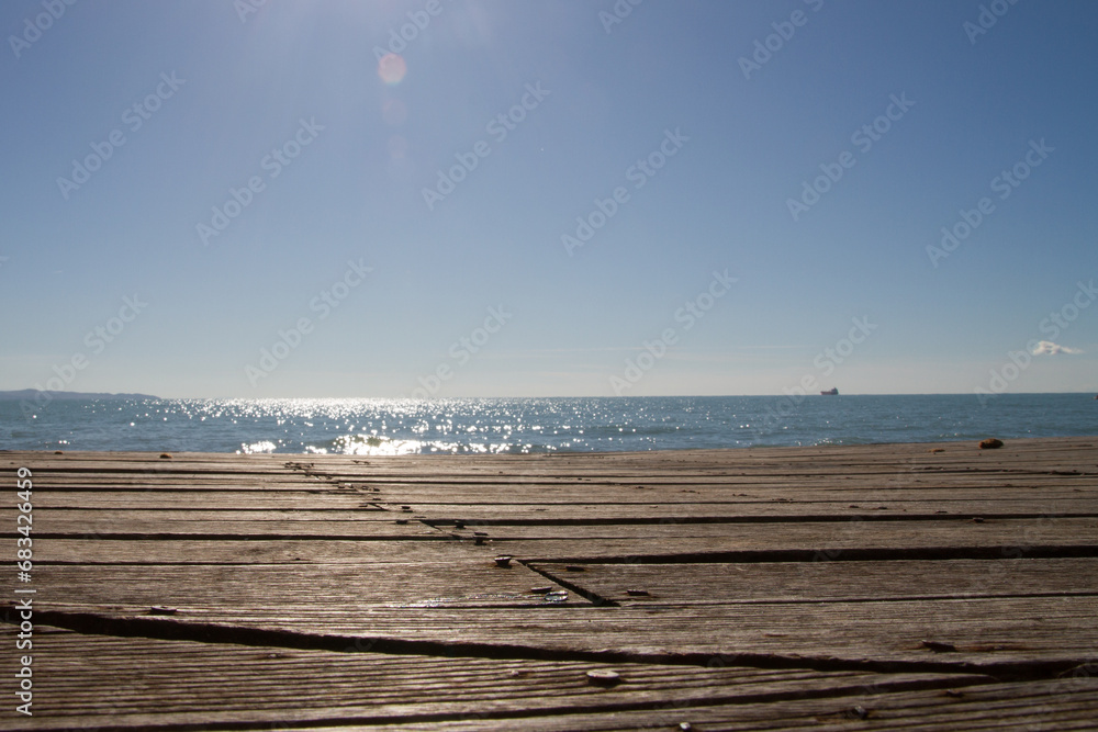 Wooden surface of the embankment, bottom view. Against the backdrop of the sea