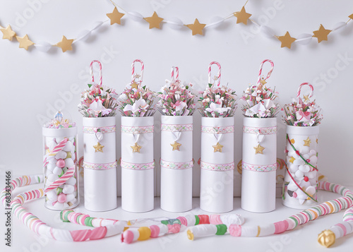 Sparkling bead necklaces, intricate jewellery boxes, and delicate ribbon bows adorn the perfectly wrapped presents, evoking a sense of festive magic and handmade charm. 