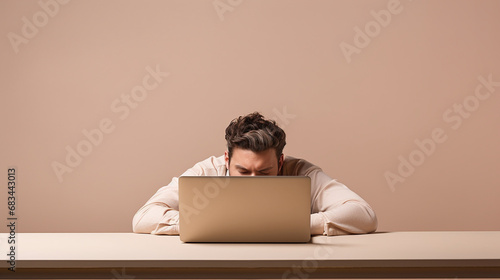 
Hyper-realistic high-quality photo of a Young frustrated exhausted man laid his head down on the table sit work at white desk with contemporary pc laptop isolated on pastel beige background. Achievem photo