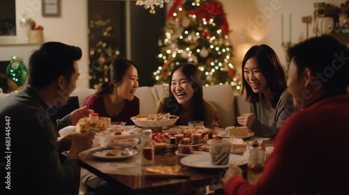 Asian family enjoying Christmas dinner. They eat traditional food. merry company celebrates christmas