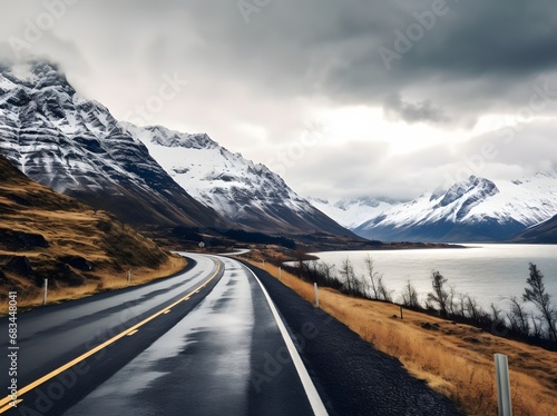 a narrow roadway going towards mountains covered with snow in in winters