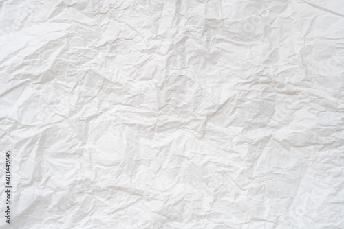 Wrinkled or crumpled white stencil paper or tissue after use in toilet or restroom with large copy space used for background texture in decorative art work