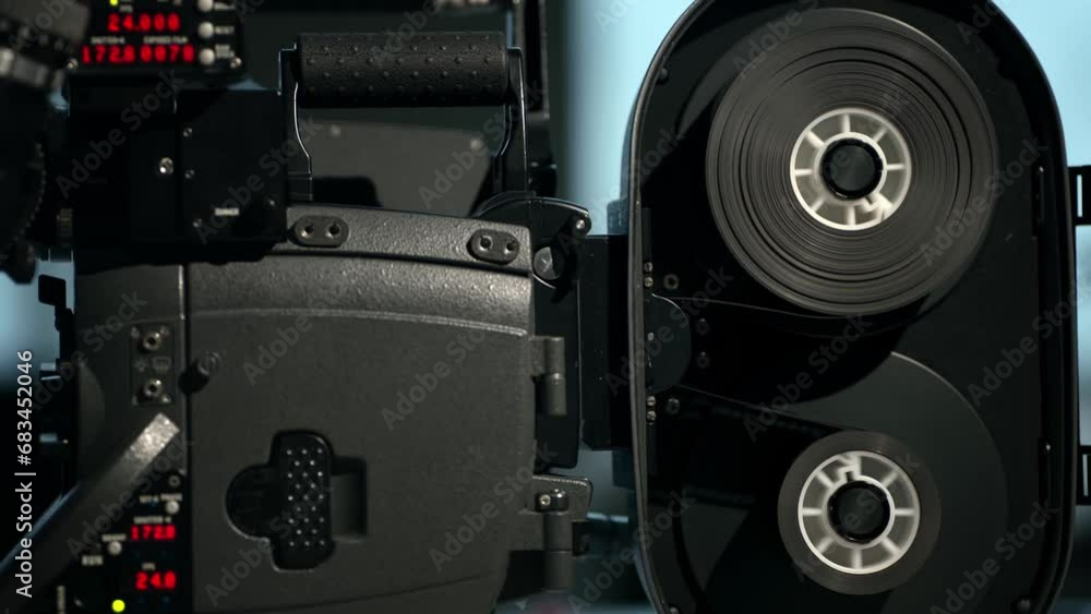 Operation of supplying and receiving film cores in 35mm camera. Closup of a film movie camera, operation of film magazine. 4k footage Operation of supplying and receiving film cores in 35mm camera. Closup of a film movie camera, operation of film magazine. 4k footage